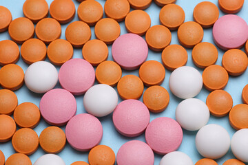 Many different pills on a blue background
