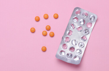 Empty blister and pills on pink background. Medicine, healthcare concept