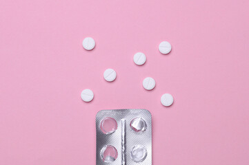 Empty blister and pills on pink background. Medicine, healthcare concept