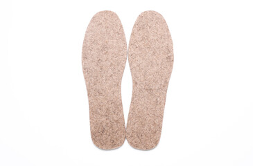 Pair of warm felt insoles on a white background