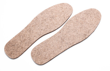 Pair of warm felt insoles on a white background