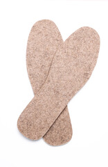 Pair of warm felt insoles on a white background