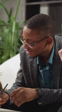 African-American man educator in glasses asks question to student and girl becomes offended at private English tuition with native speaker at home slow motion