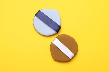 Makeup sponges blenders on yellow background. Beauty concept