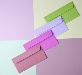 Group of colored envelopes on colored paper. Creative layout