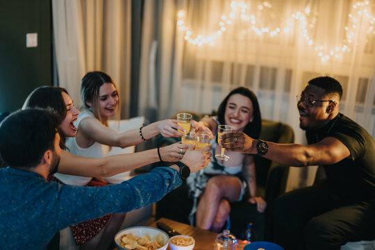 A lively social group cheers together, enjoying a friendly celebration in a warm ambiance.