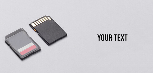 Two sd memory cards on gray background. Creative layout. Space for your text