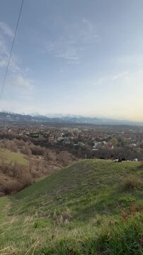 The rolling green slopes of Kok Tobe Hill overlooking the southeastern suburbs of Almaty in Kazakhstan&rsquo;s mountain‑rimmed region.