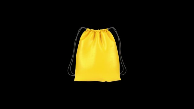 Yellow backpack falling and unfolding on black background