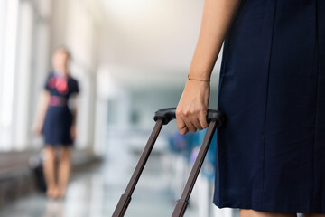 Closeup hand woman Walking in airport. Cabin crew, air hostess working in airplane. Service mind....