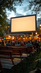 Outdoor movie night, city park, audience watching blank screen
