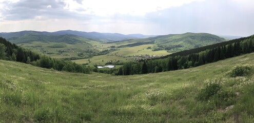 Obraz premium Serene valley view, lush green meadows, distant hills, and a small lake