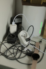 A cluttered desk with tangled cables and many outlets creates a chaotic, hardtomanage workspace