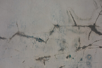Cracked concrete surface revealing texture details in urban setting during daylight hours