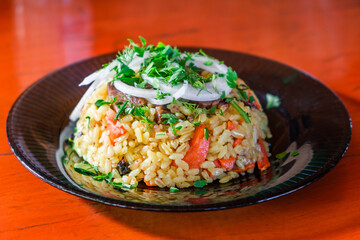 pilaf with meat on plate, selective focus