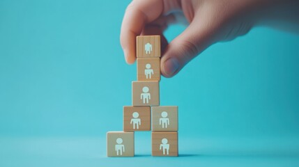 Hand building human pyramid, teamwork concept, blue background, business growth