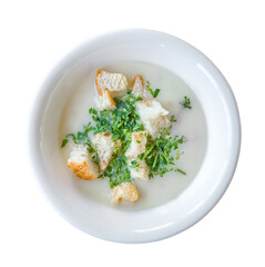 cream soup with croutons and herbs, top view, isolated on white background with clipping path
