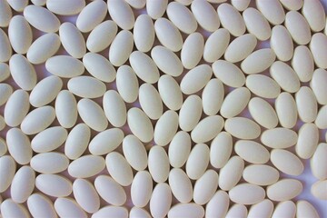 White tablets on a white background. Medicines and vitamins.