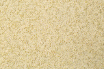 The towel is a yellow cloth.Background of a yellow terry woodpile.