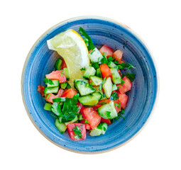 vegetable salad of cucumbers and tomatoes in bowl, top view, isolated on white background with clipping path