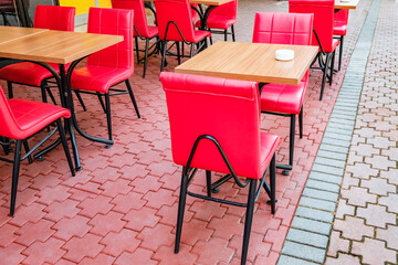 tables and red chairs in outdoor cafe