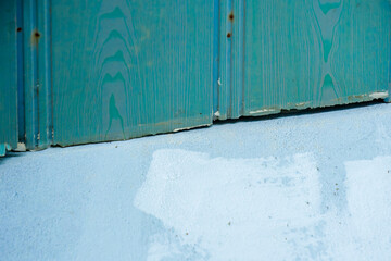 Close-up of a worn green metal panel with peeling paint