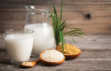 Rice milk in a glass on the wooden table.  Non dairy, plant based alternative milk, vegetarian, healthy food