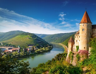 landscape with old castle and danube river in wachau austria
