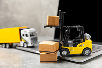 Yellow forklift on bright textured background. Logistics concept. Logistics and supply chain...