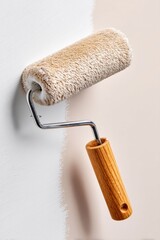 Paint roller with soft texture and wooden handle applying fresh coat of paint on wall in home renovation project showcasing creativity and transformation