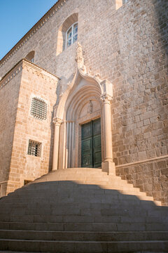 Vertical photograph of the door and staircase of Dominican Monastery (Dominikanski samostan) of Dubrovnik Old Town in Croatia on a sunny day. Ideal for travel brochure, magazine cover, poster.