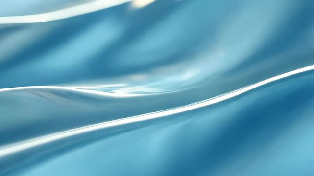 Abstract fluidity: glossy blue waves in motion with light reflection