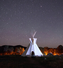 white teepee with stary sky and glowing background © Jerry