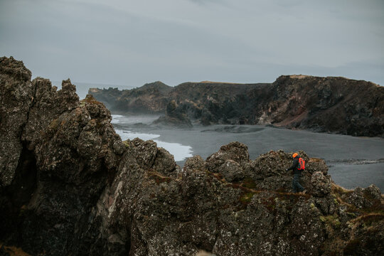Man Exploring and Photographing Iceland&rsquo;s Black Sand Beach