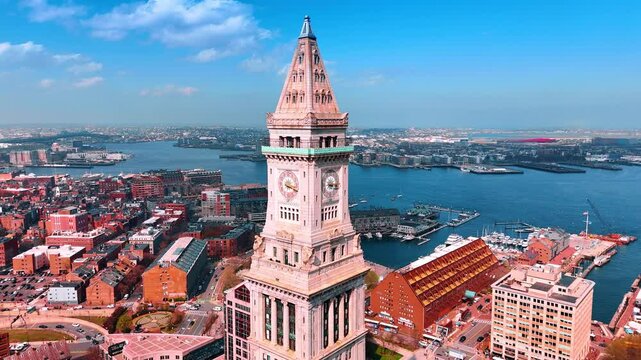 Spectacular view of Custom House Tower at McKinley square in Boston. Going down along the beautiful building at the backdrop of azure waterscape.