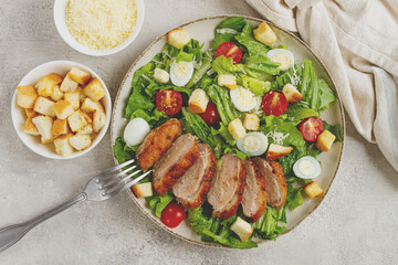 Caesar salad, with duck breast, on a light plate, on a light background, homemade, no people,