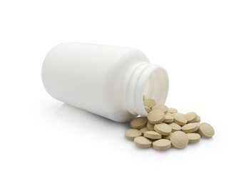 Vitamin tablets or food supplements in plastic medicine bottle jar isolated on white background