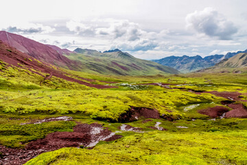 Red valley mountains Vinicunca in Peru near Rainbow mountain Cuzco. Natural wonder sightseeing in South America. Peruvian red soil and rock formation mountain hills near Cusco in the Andes