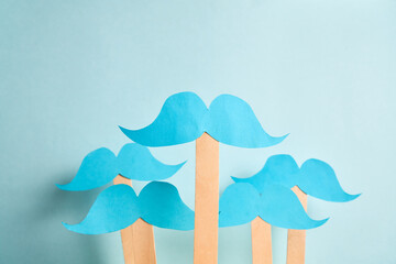 Blue mustaches on flat blue background. Prostate cancer awareness month and men health