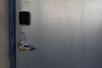 Metal door in back of theatre.  Keycard access.