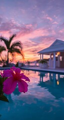 A stunning view of the pool at sunset, with the sky painted in hues of pink and purple, reflecting