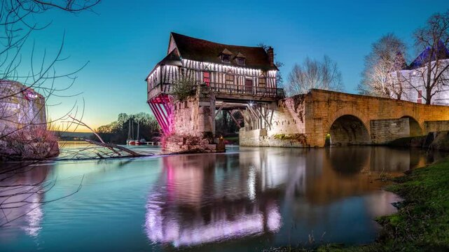 France, Eure, Vernon, panoramic view of of reflection of the Old Mill on the water of the Seine river, illuminated at sunset