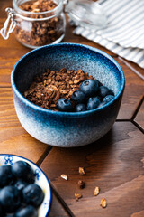 Granola with chocolate, nuts and fresh blueberries. Healthy and simple breakfast.