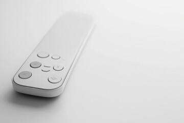 A minimalist white remote control with simple buttons sits on a white background.