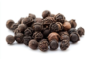 Obraz premium Aromatic black peppercorns a close up view of dark brown peppercorns piled on a white background showcasing their texture and rich