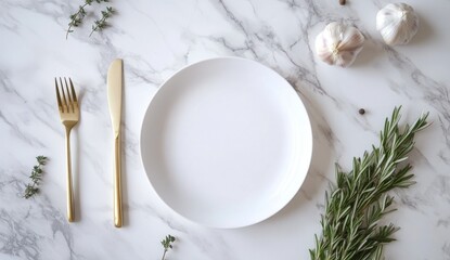 Empty white plate, gold cutlery, and fresh herbs on marble surface