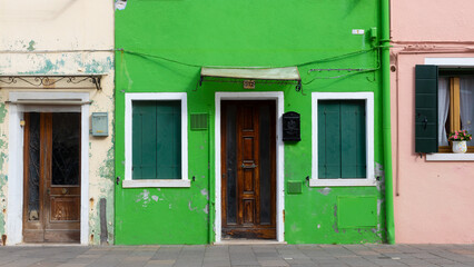 Colorful old houses with peeling paint in Burano Italy
