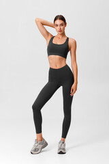 Fitness woman. Athletic girl on the gray background