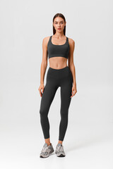 Fitness woman. Athletic girl on the gray background