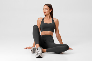 Fitness woman. Athletic girl on the gray background